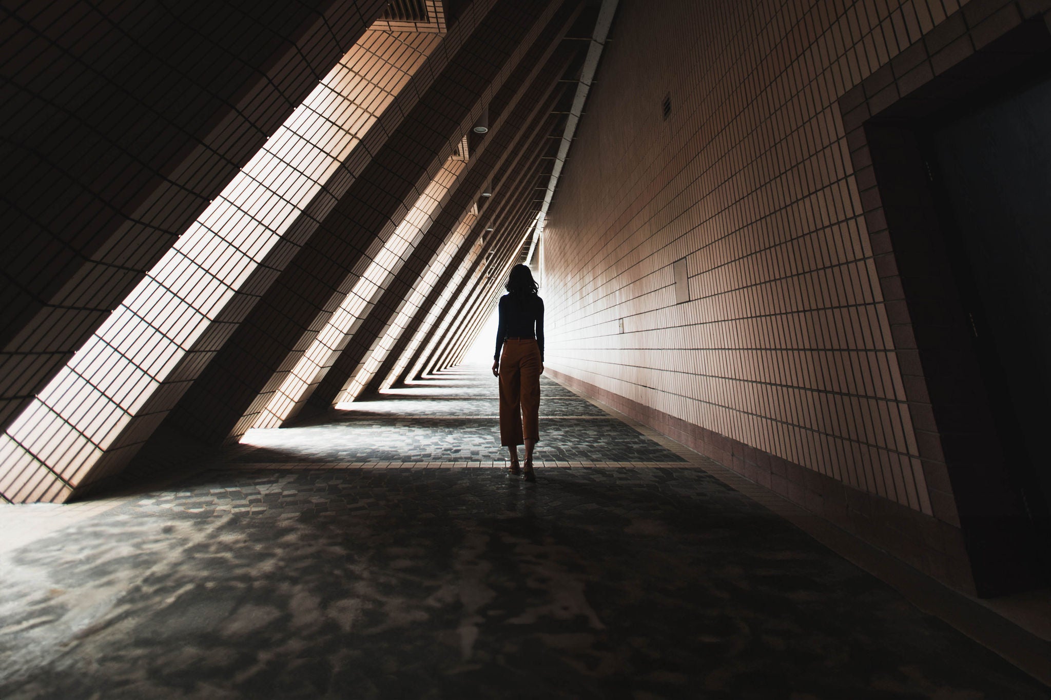 Rear view of asian woman in tunnel