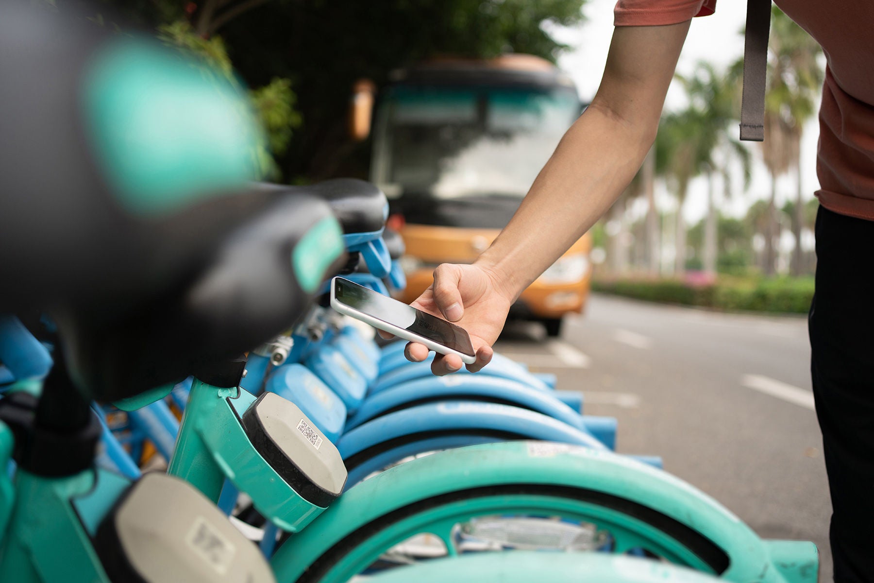 Asians use their smartphones to scan the QR code on the bicycle to unlock the bicycle