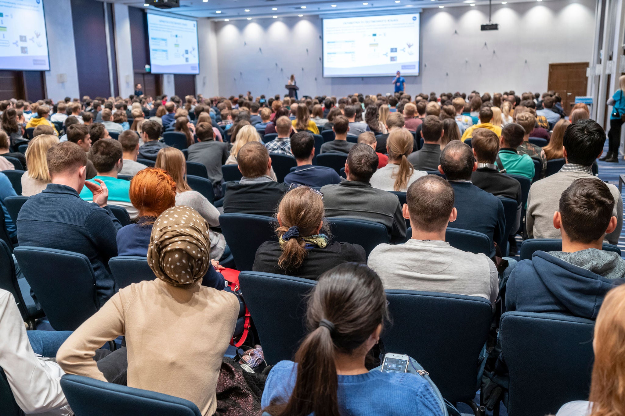 Image of a conference that takes place in a large conference room